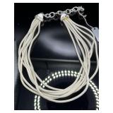 Multi strand silver tone necklace with acorn charm