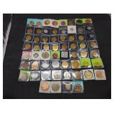 Collection of 60 vintage tokens in holders