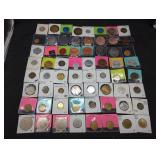 Collection of 64 vintage tokens in holders