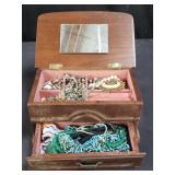Group of costume jewelry in wooden jewelry box