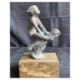 Bronze sculpture of girl riding a turtle