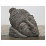 Large resting Buddha head made of fiberglass