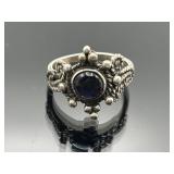 Sterling silver ring with purple center stone,