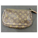 Designer style makeup bag marked Louis Vuitton
