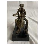 Bronze sculpture playing the cello