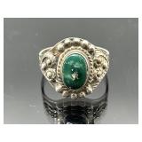 Scratch tested silver ring with green gemstone