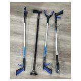 Group of metal grabbers and one walking cane