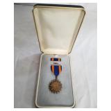 Military medal in case. Display case.