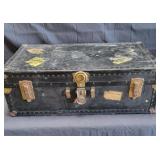 Antique steamer trunk with original travel hotel