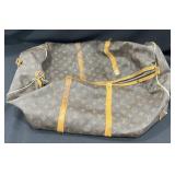 Designer style duffel bag marked Louis Vuitton
