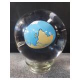 Reverse painted glass globe encased in glass