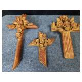 Group of three terracotta Folk Art floral crosses