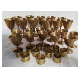 Collection of brass goblets and napkin holders.