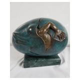 Bronze egg sculpture on marble base