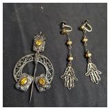 Group of silver earrings and matching pin