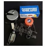 Box of retractable cord lights