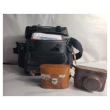 Group of two cameras and pair of binoculars with