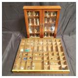 Group of perfume bottles in wood cabinet &