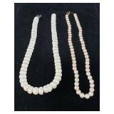 Pair of pearl necklaces, one with 14 kt gold clasp