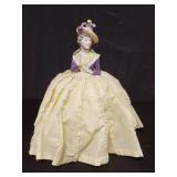 Porcelain dresser doll, 10" h. x 6" diam.