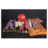 Box of sports medals and baseballs