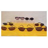 Group of various sunglasses.  In  plastic bag