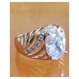 Gold washed ring with clear crystal stones .