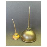 Pair of vintage thumb pump oil cans