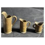 Miniature brass bullet case pitchers tallest