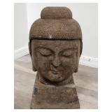 Vintage stone Buddha head on pedestal