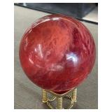 Red art glass orb on stand
