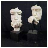 Pair of modern sculptures blowing kisses