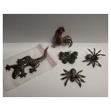 Group of five sterling silver brooches