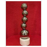 Chrome sphere statue on marble