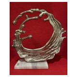 Metal abstract statue on marble