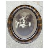 Antique oval framed cupid picture
