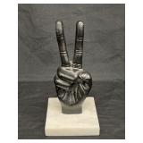 Metal peace sign on marble base