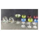 Group of colored glass wine glasses & hand