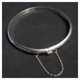 Sterling silver bangle bracelet with safety chain
