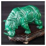 Malachite rhino sculpture on a wood base