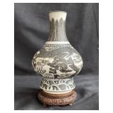 Vintage porcelain Chinese vase on carved wood base