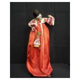 Vintage Asian doll on stand