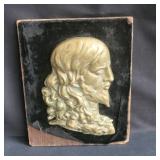 Vintage religious brass wall plaque on wood