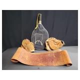 Box of vintage baseball gloves, tennis racket,