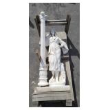 Large woman next to a light pole stone statue