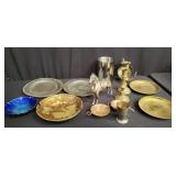 Group of brass candle holders, brass saucers,