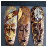 Group of hand carved wood Indonesian wall masks