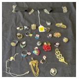 Group of costume jewelry rings & pins