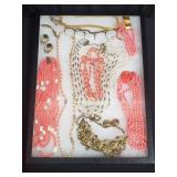 Group of costume jewelry in Riker box