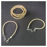 Three brass and sterling silver bracelets